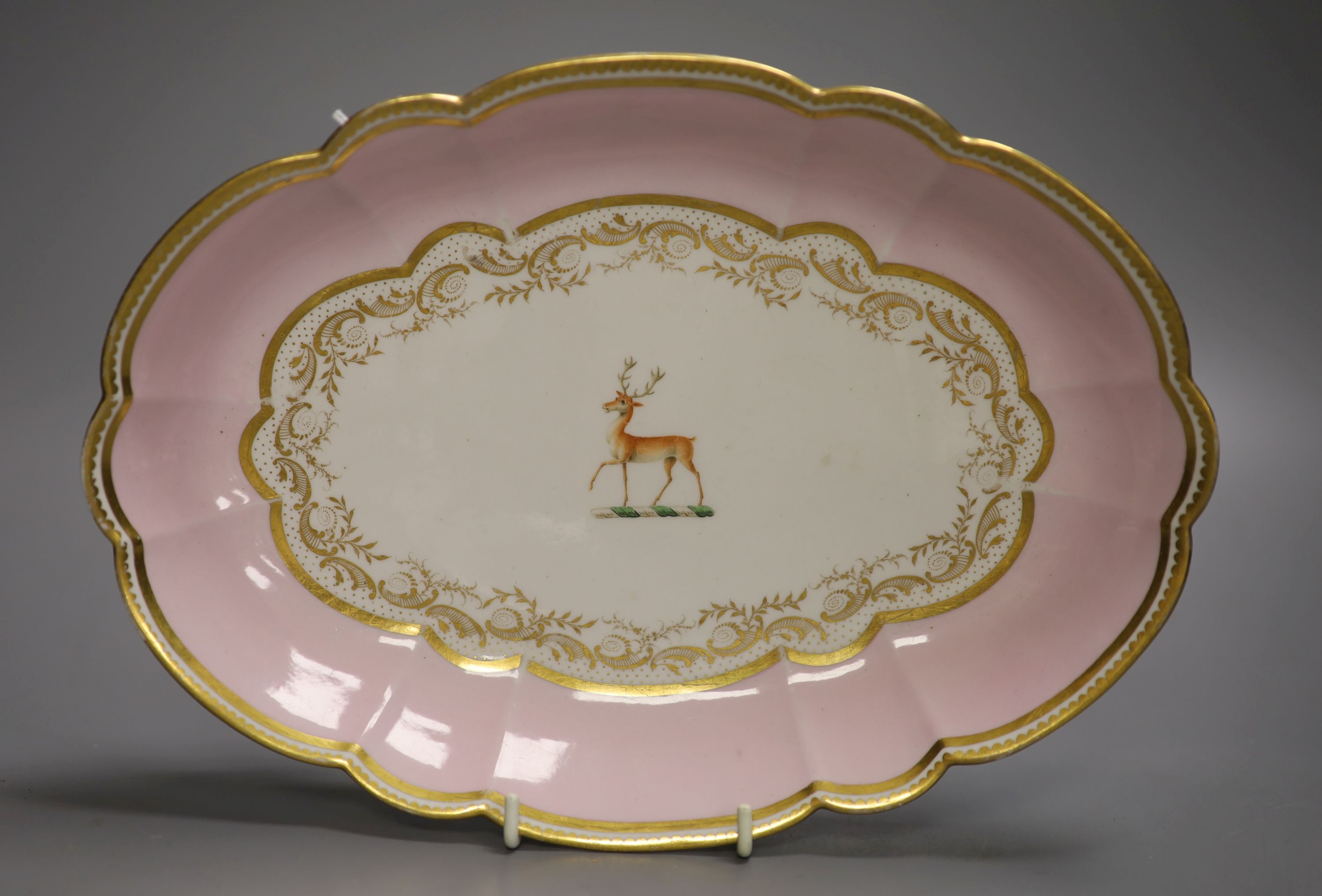 A Barr Flight and Barr pink ground oval dish with elaborate gilding and a family crest of a stag, Royal Warrant mark, c.1810, length 29